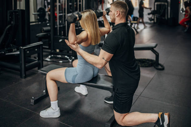 istock Woman training with personal trainer 1389552372