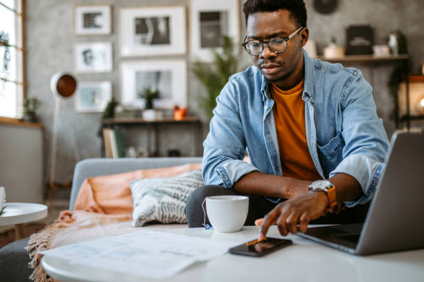 istock Man at home paying bills online 1389552736