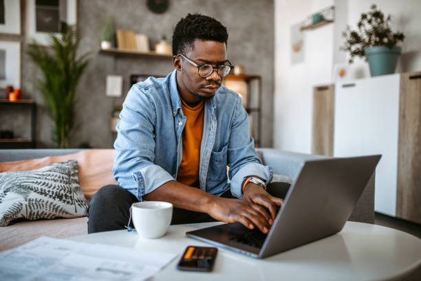 istock Man at home managing household finances 1389552757