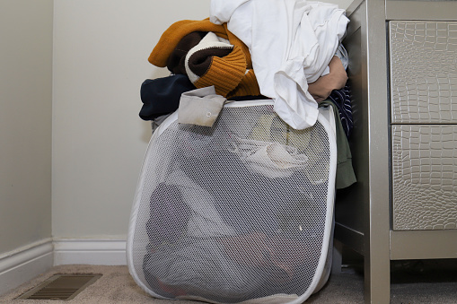A pile of dirty clothes in a laundry basket