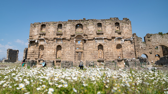 Photo of senior woman and two daughters in ancient city of Aspendos, Antalya, Turkey. Shot under daylight.