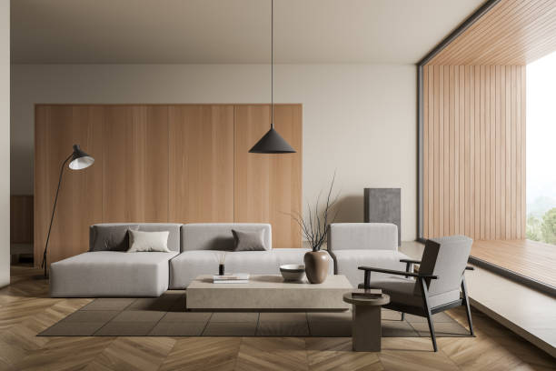 istock Bright living room interior with sofa and armchair, panoramic window 1389556616