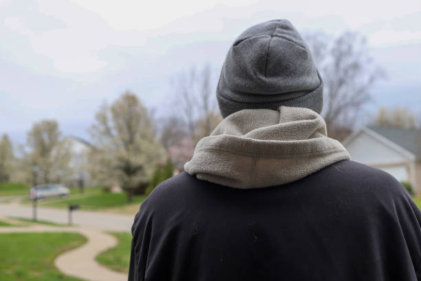 istock A rear view of a man standing alone outside 1389556671