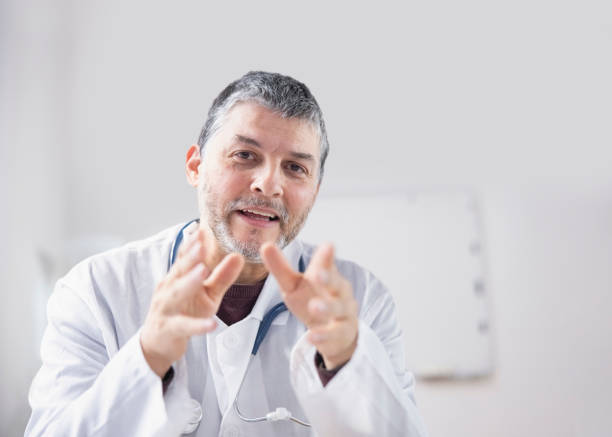 istock Confident male doctor talks with patient during virtual appointment 1389557341