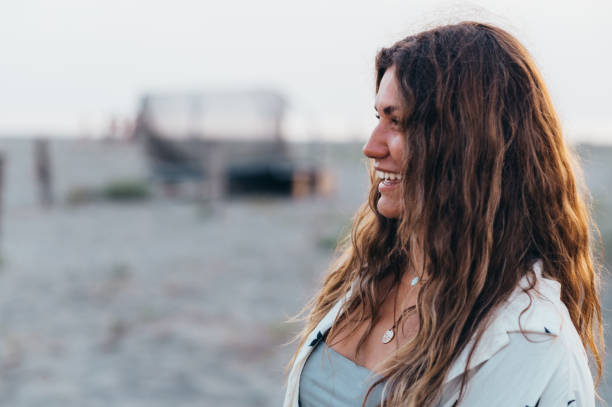 istock Beautiful girl posing on the beach during sunset 1389557468