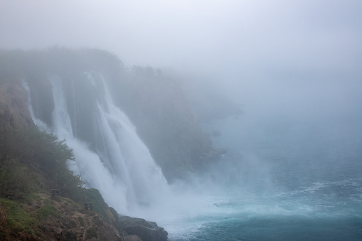 Photo of Duden Waterfalls in fog, Antalya, Turkey. No people are seen in frame. Shot under daylight.