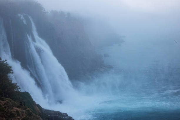 Photo of Duden Waterfalls in fog, Antalya, Turkey. No people are seen in frame. Shot under daylight.