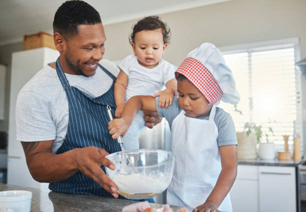istock Shot of a father baking at home with his two daughters 1389559015