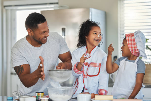 istock Shot of a father baking at home with his two daughters 1389559042