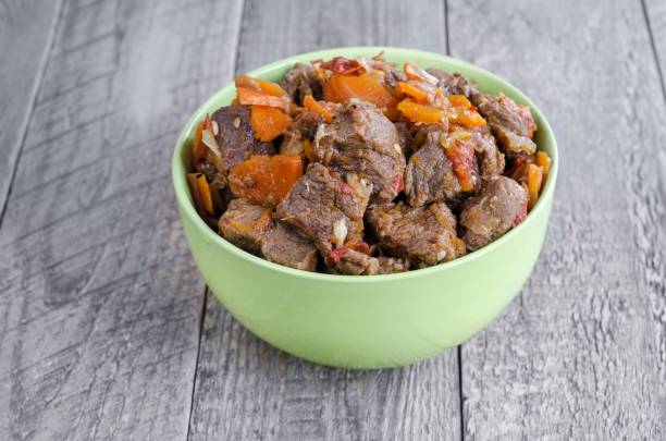 Stewed veal with onions, carrots and pine nuts. Rustic style, the concept of delicious food stock photo