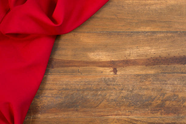 Red fabric on left side of frame.  Wood table.
