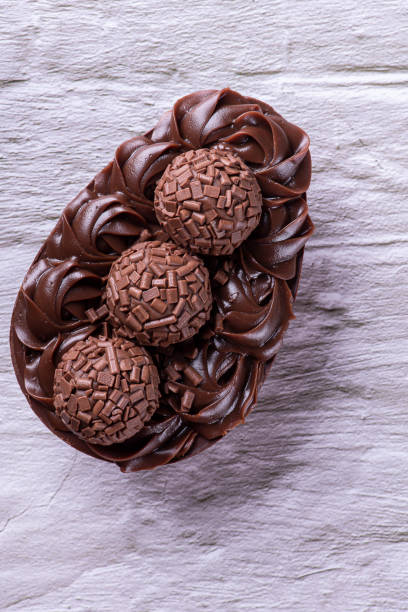istock Handmade chocolate Easter egg, Brazilian style. Made with chocolate and brigadiers. Top view. 1389560847