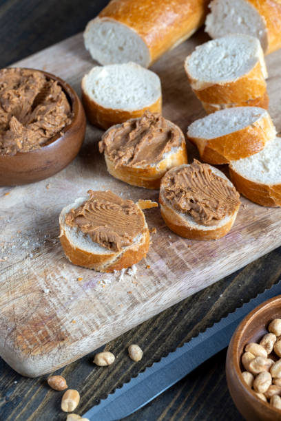 istock peanut paste with pieces of peanuts and white baguette 1389562569