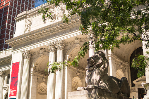 Manhattan, New York City, USA - June, 27. New York Public Library facade with lion statue and trees