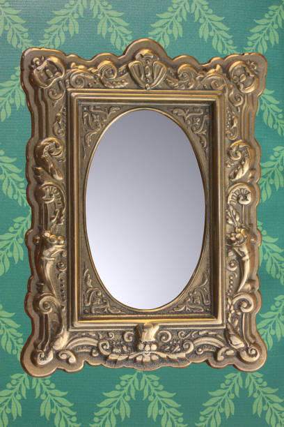 istock Old style mirror hanging on a wall decorated with wallpaper 1389568755