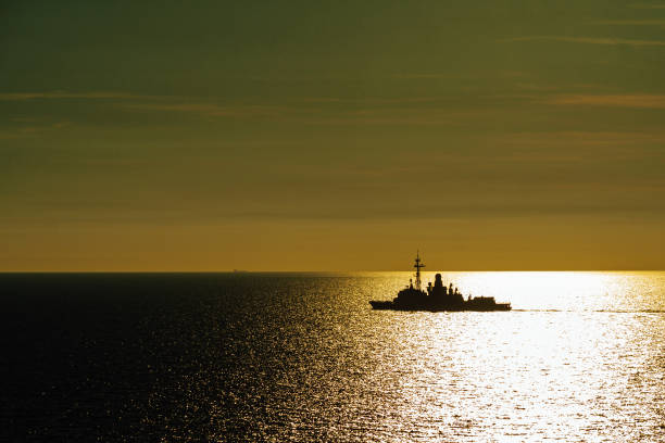 istock View of a ship sailing through open ocean during the sunset. 1389569986