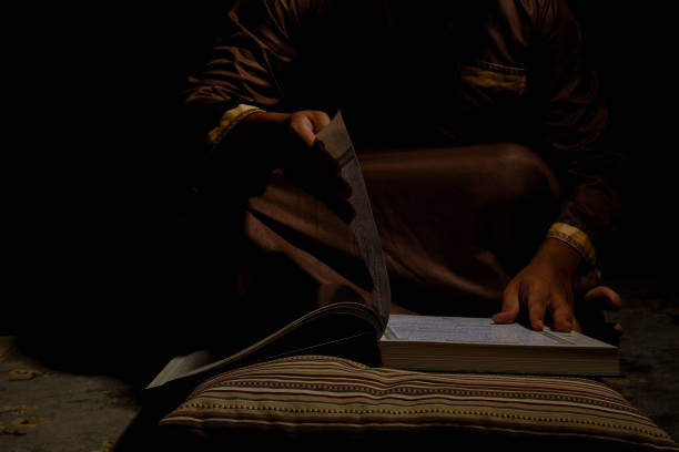 istock Turn the Quran Page 1389577906