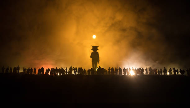 Creative artwork decoration - Russian war in Ukraine concept. Crowd looking on giant explosion and silhouette of giant person. Selective focus