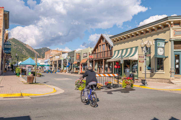 In Idaho Springs, a man rides his bicycle downtown stock photo
