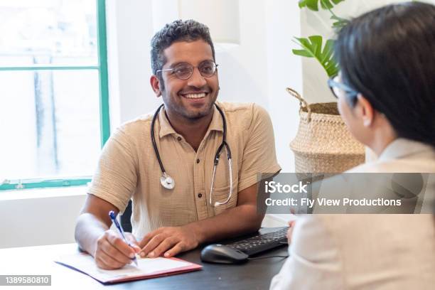 Cheerful Male Doctor Meeting With A Patient Stock Photo - Download Image Now - Doctor, Australia, Patient