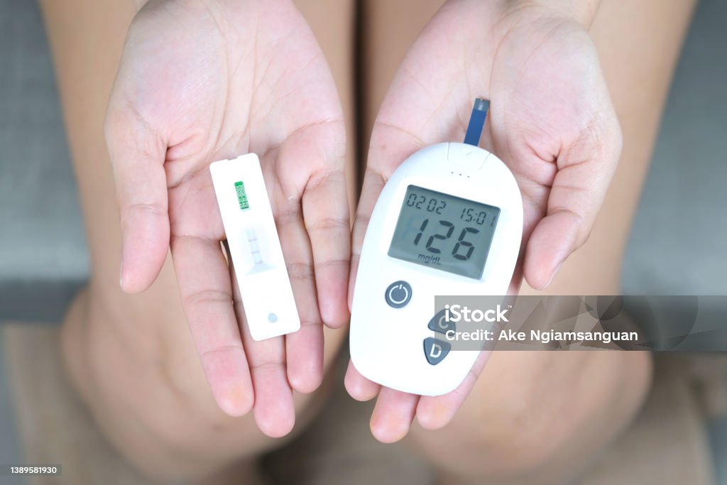 Handchecking Diabetes And High Blood Sugar With Digital Blood Pressure  Monitor And Covid19 Test Results Health And Medical Concepts Stock Photo -  Download Image Now - iStock