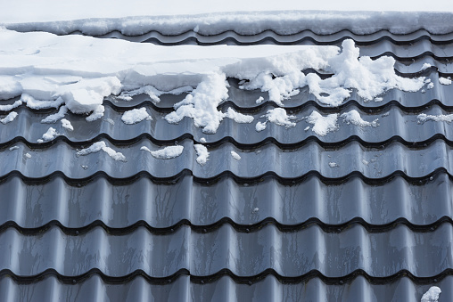 Melting snow on the house roof top.