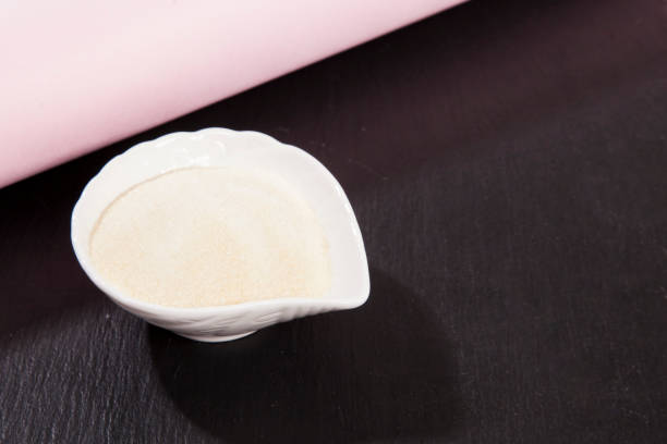 istock Collagen powder, on black background. 1389583069