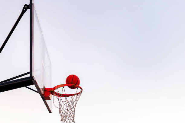 istock ball entering in a basket with sky at background 1389586642