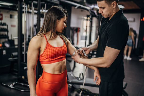 istock Coach measuring woman's arm 1389588271