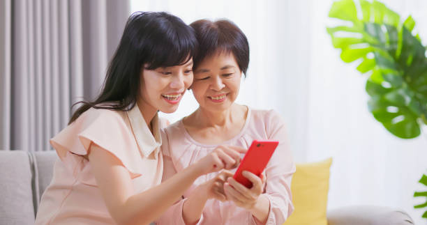 istock Daughter show smartphone to mom 1389590630