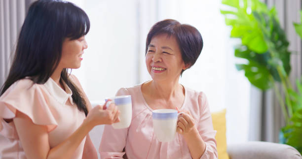 istock Mom and daughters drink together 1389590661