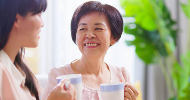 istock Mom and daughters drink together 1389591332