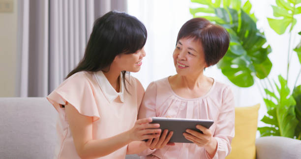 istock Daughter show tablet to mom 1389591429