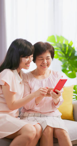 istock Daughter show smartphone to mom 1389591534