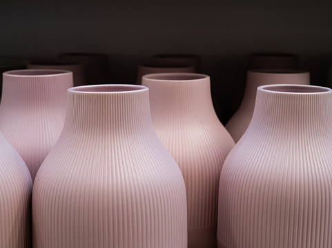 White funeral urn jar shape complete view isolated on dark wooden background.Philosophical concept photo of life ,death, cremation, reincarnation, spiritual , religious , soul ,spirit and spirality