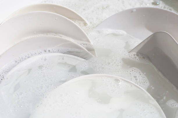 istock Dish washing, Dirty dishes soaking in kitchen sink. 1389594784