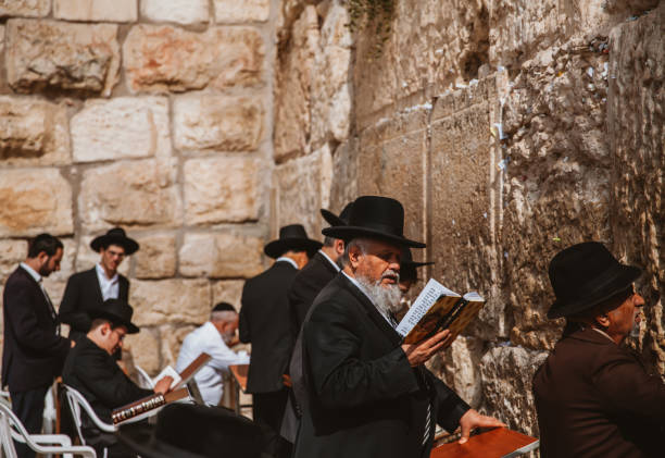 Life in Jerusalem Jerusalem, Israel- April 30, 2022: Jewish gather around at the Western Wall, the most sacred site in Judaism to pray, whis is also one of the most amazing things to see to travellers. hasidism photos stock pictures, royalty-free photos & images