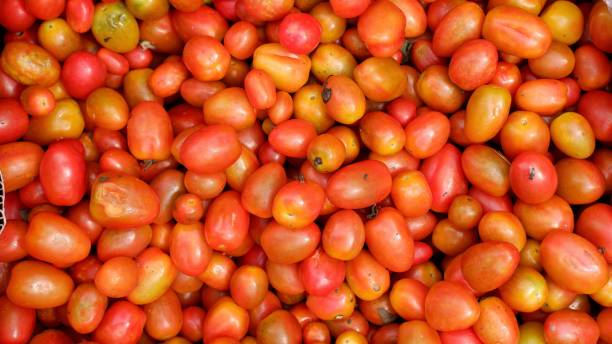 istock Stacked tomatoes cherry in traditional market, tomatoes cherry background 1389603439