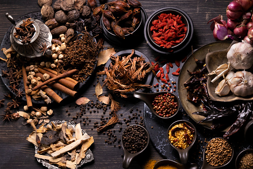 Various type of oriental earthy flavor dry spices on dark wooden table such as star anise, black pepper, cinnamon, bay leaf, for medicinal and herbal use in healing and cooking concept