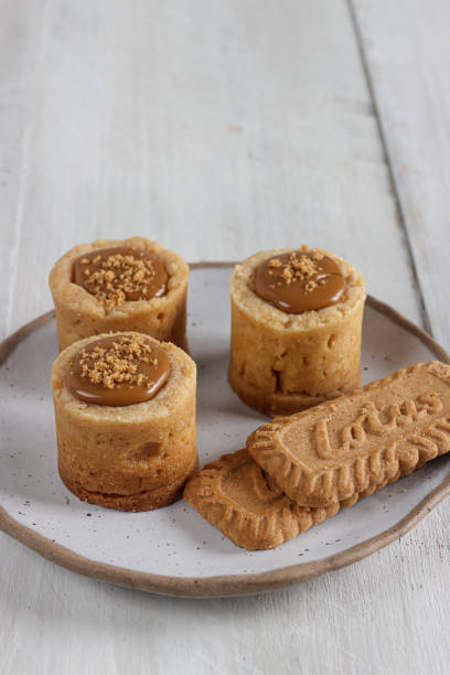 Lotus biscoff tartlet pastries topped with lotus biscoff spread and biscuits sprinkles.
