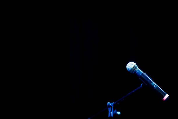 istock Close-up microphones ready on stage in the performance venue. 1389609115