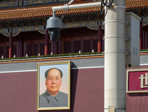 Beijing, China , June 2018: Security guard on the entrance of the famous Forbidden palace city with the portrait chairman Mao Zedong in Beijing, China.