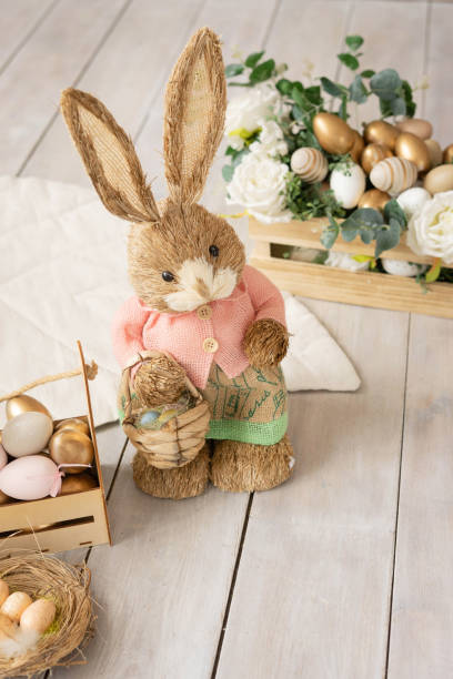 istock Easter bunny with a basket, eggs, flowers and a nest. 1389613100