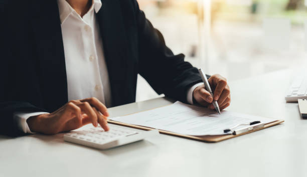 istock Accountant working with data documents calculating on business report. 1389615961