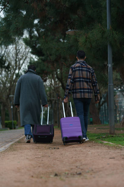 istock Two men travel with luggage 1389617605