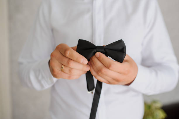 istock man holding a black bow in his hands. 1389622933