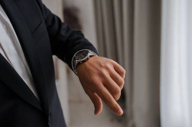 istock man hand with a wrist watch on it. 1389623059