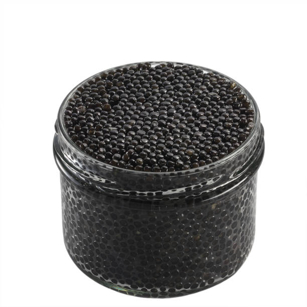 istock Black caviar in a glass jar on a white background isolate 1389623882