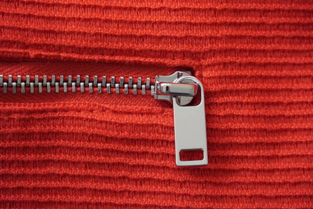 istock Silver colored metal zipper on a red fabric. 1389625939