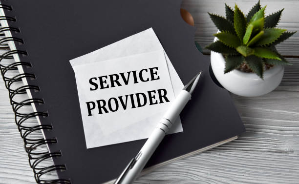istock SERVICE PROVIDER - words in a white notebook against the background of a black notebook with a pen 1389627598